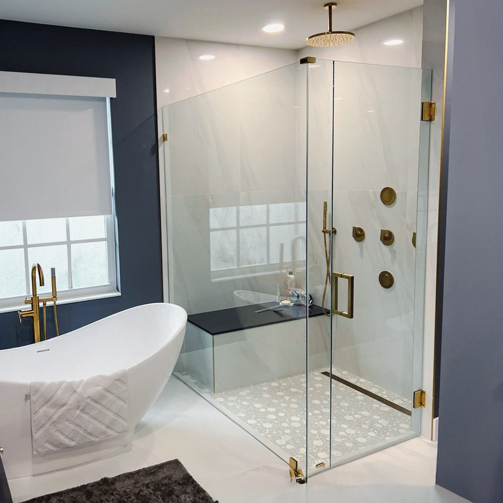 Luxury glass shower with brass hardware in contemporary bathroom setting.