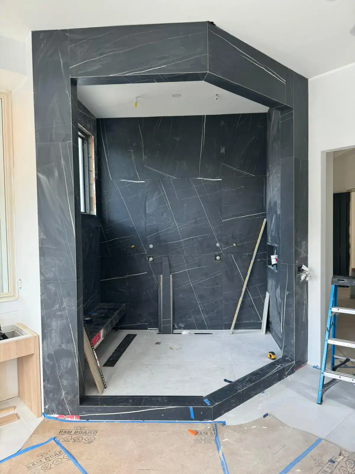 Crisp black marble wall mirror for sophisticated home or commercial interiors. Durable, stylish glass surface, custom installations.