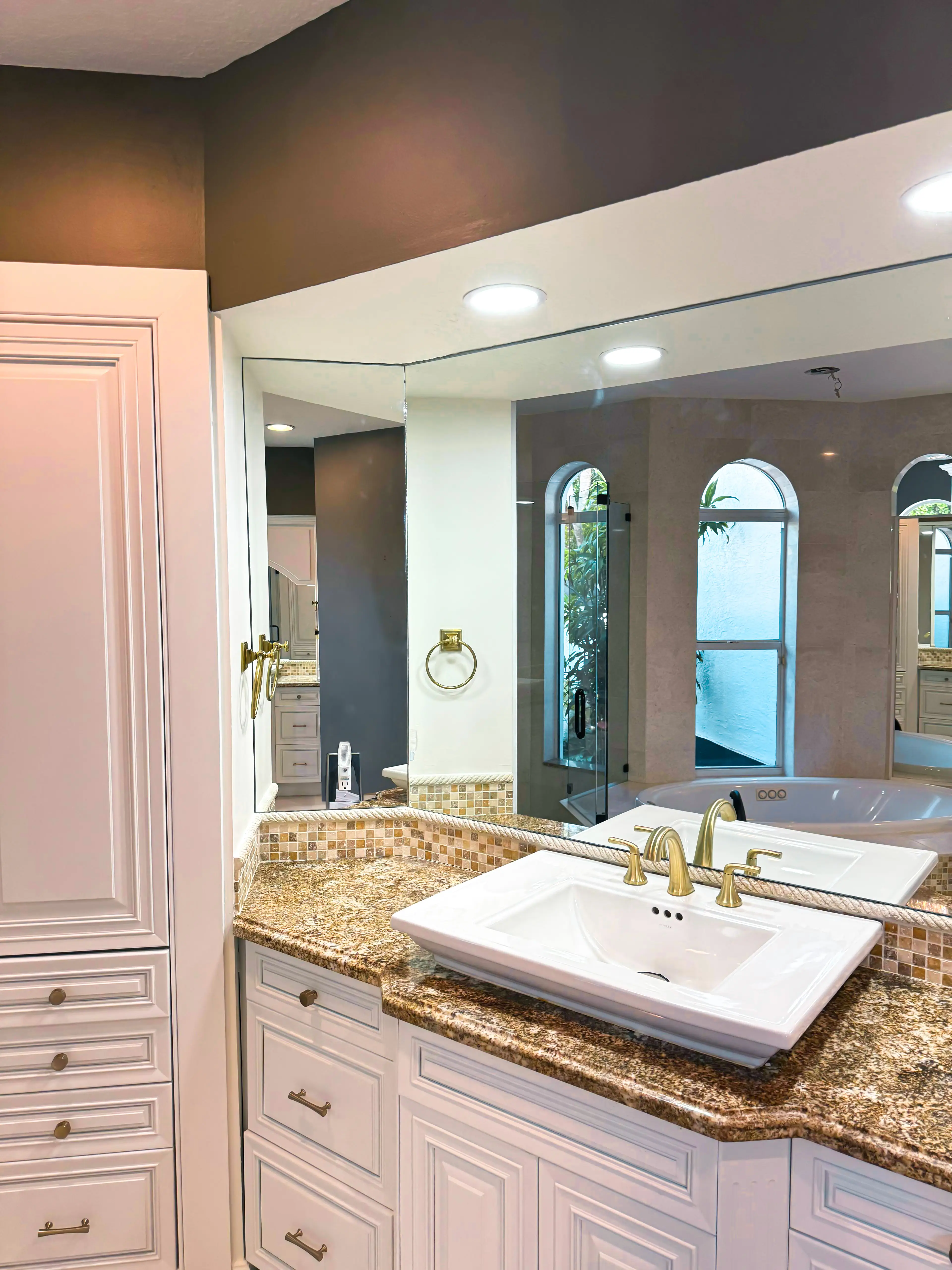 High-quality glass and mirror installation in upscale bathroom setting.