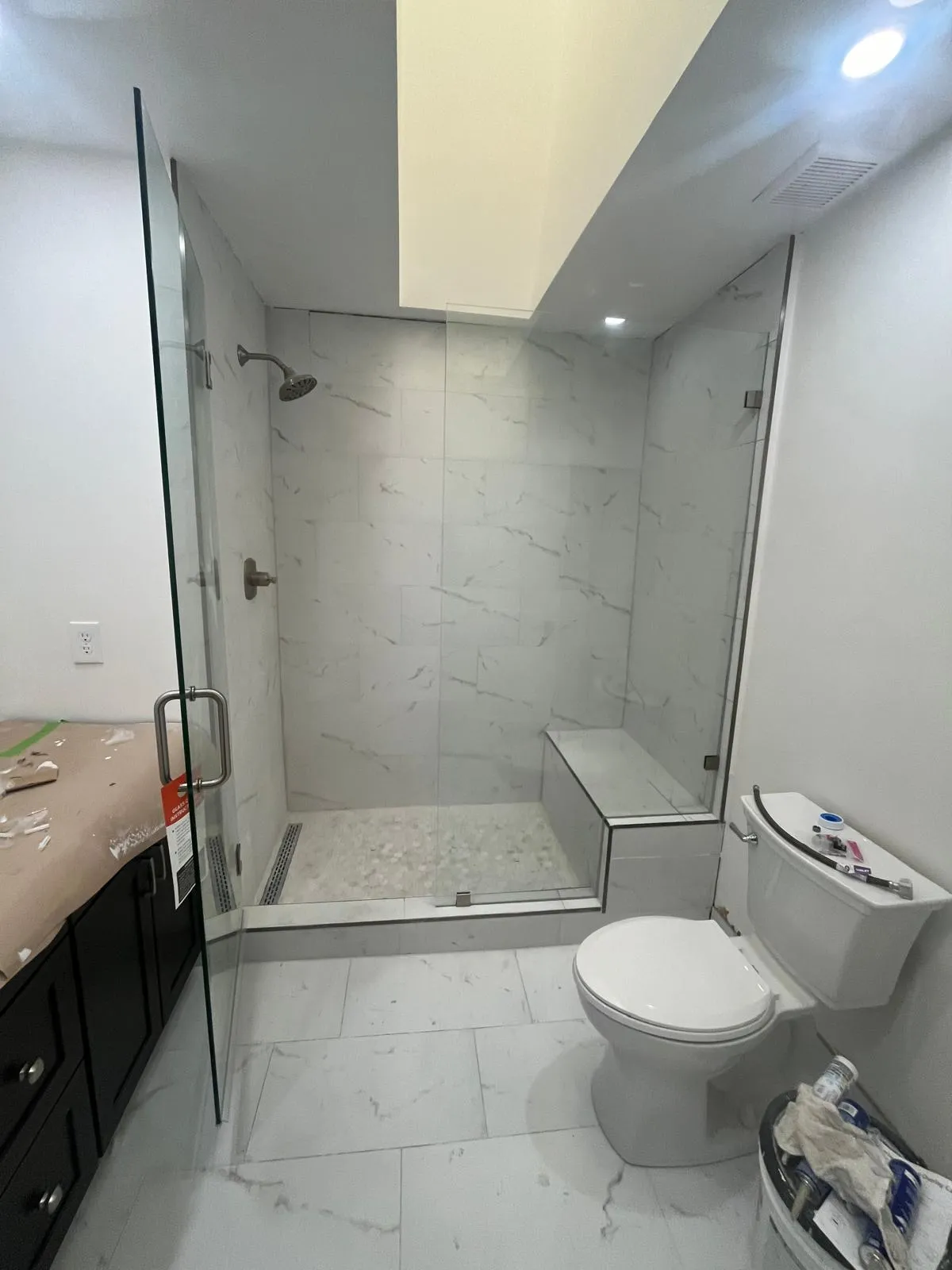 Stainless steel bathroom fixtures with marble accents.