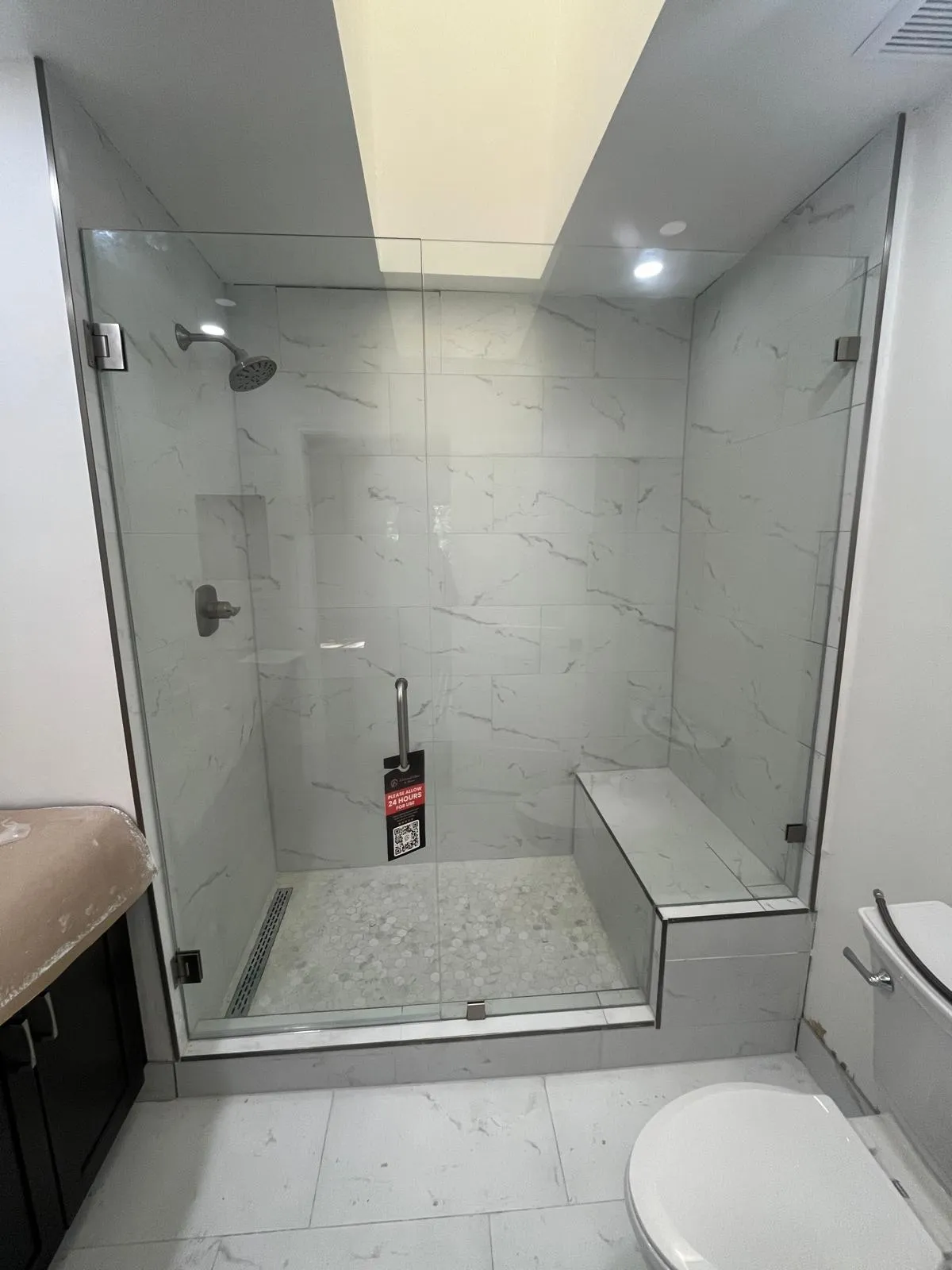 High-quality glass shower enclosure with marble wall design for modern bathrooms.