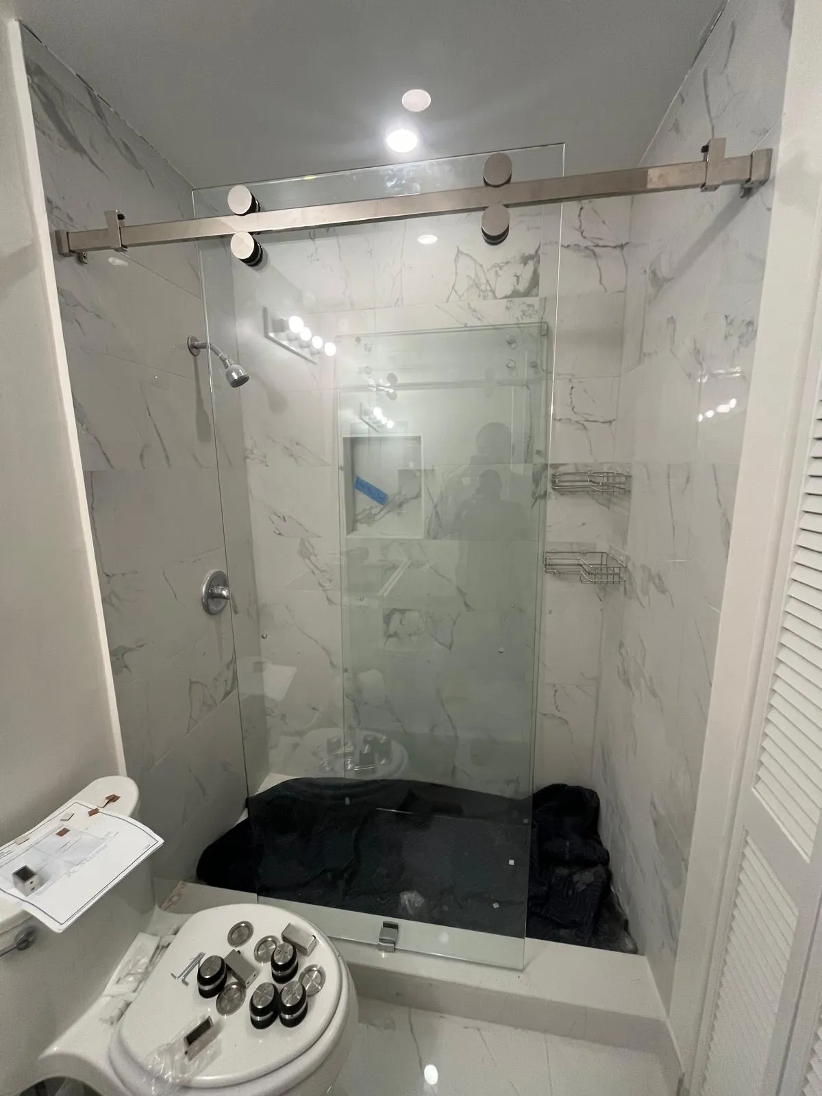 High-quality glass shower door with stainless steel hardware for modern bathrooms.