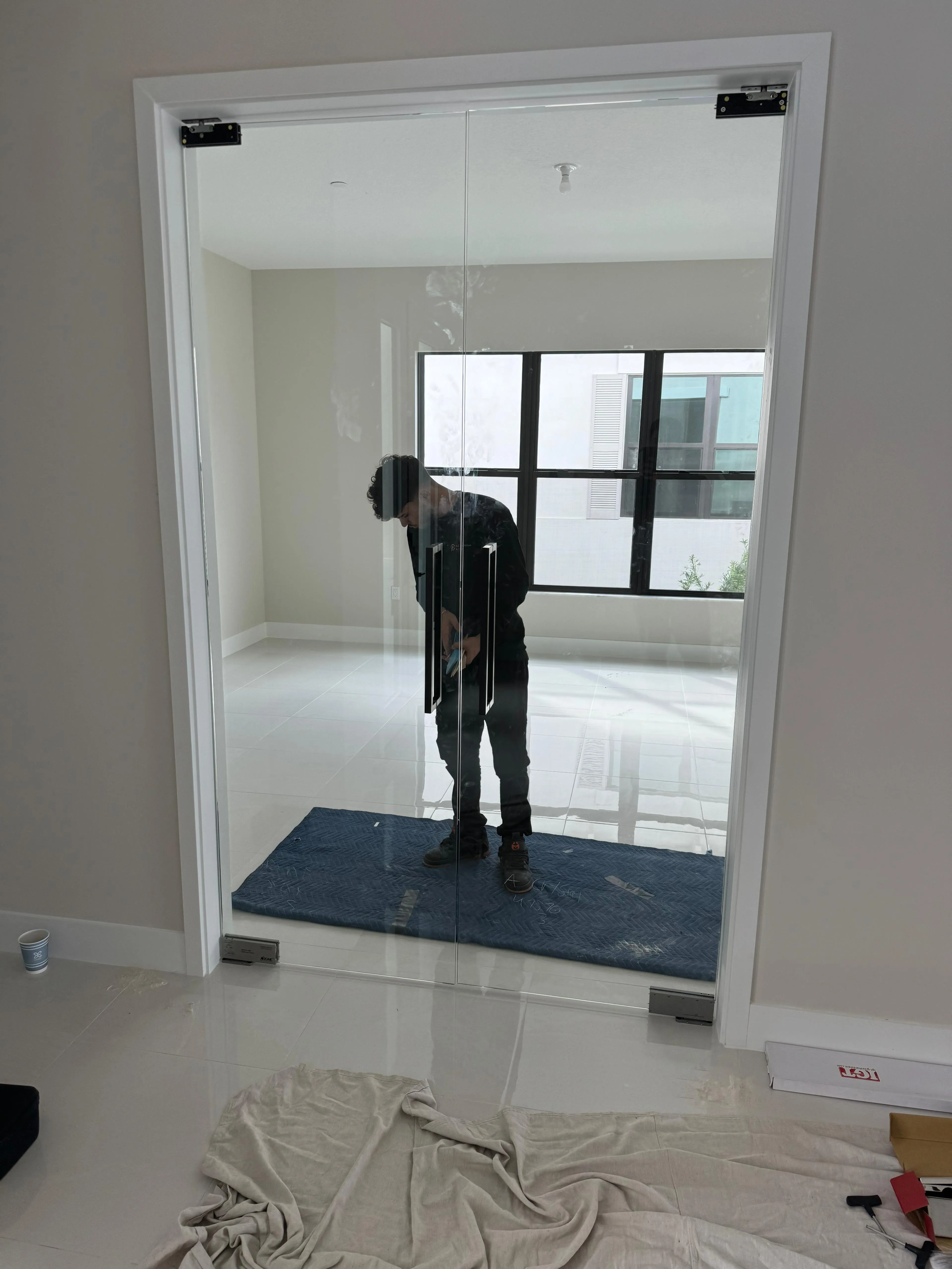 Mirror glass door installation for stylish home or office spaces, enhancing natural light and privacy.