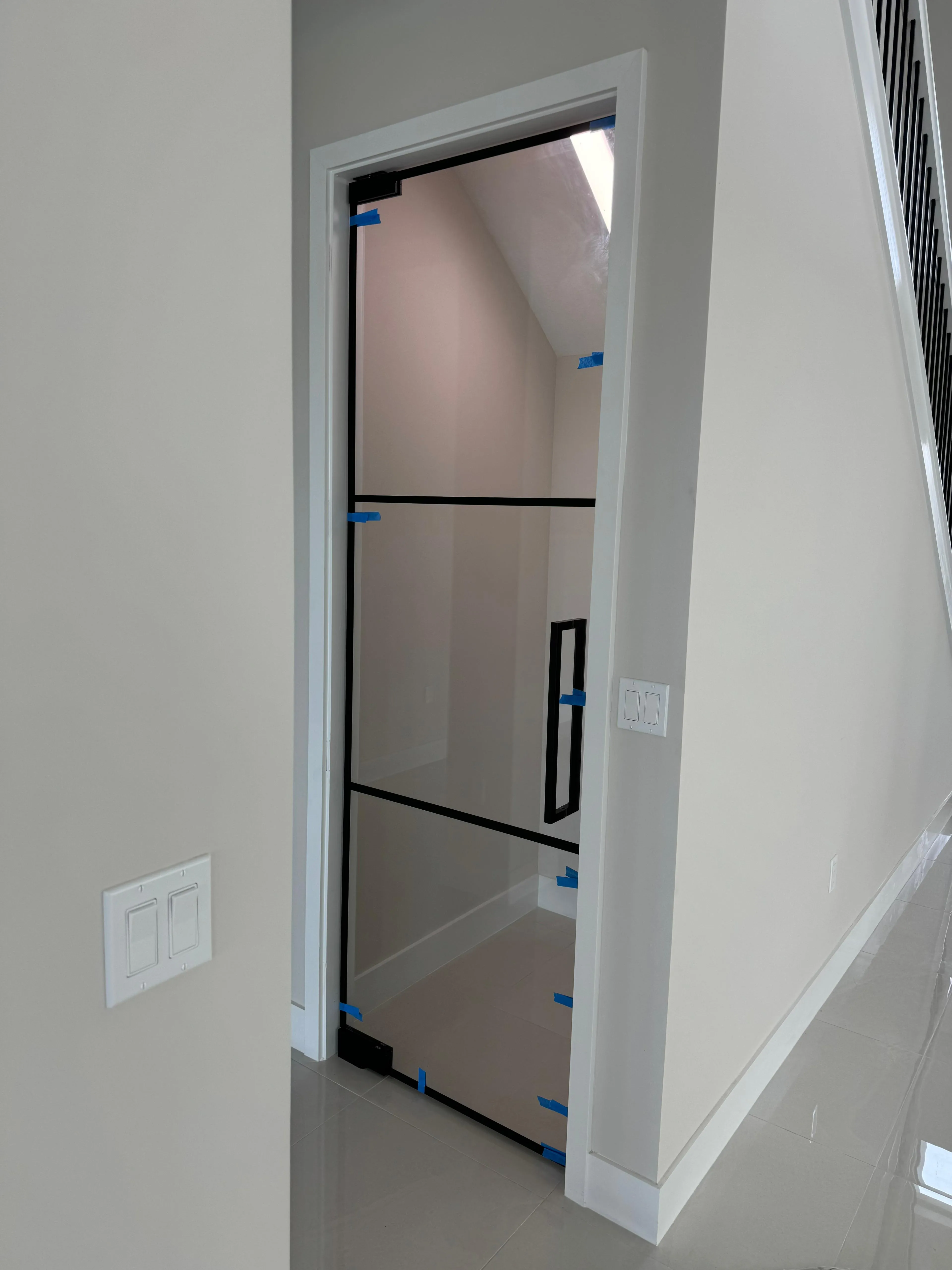 Custom glass shower door installation with sleek frameless design. Perfect for modern bathrooms.