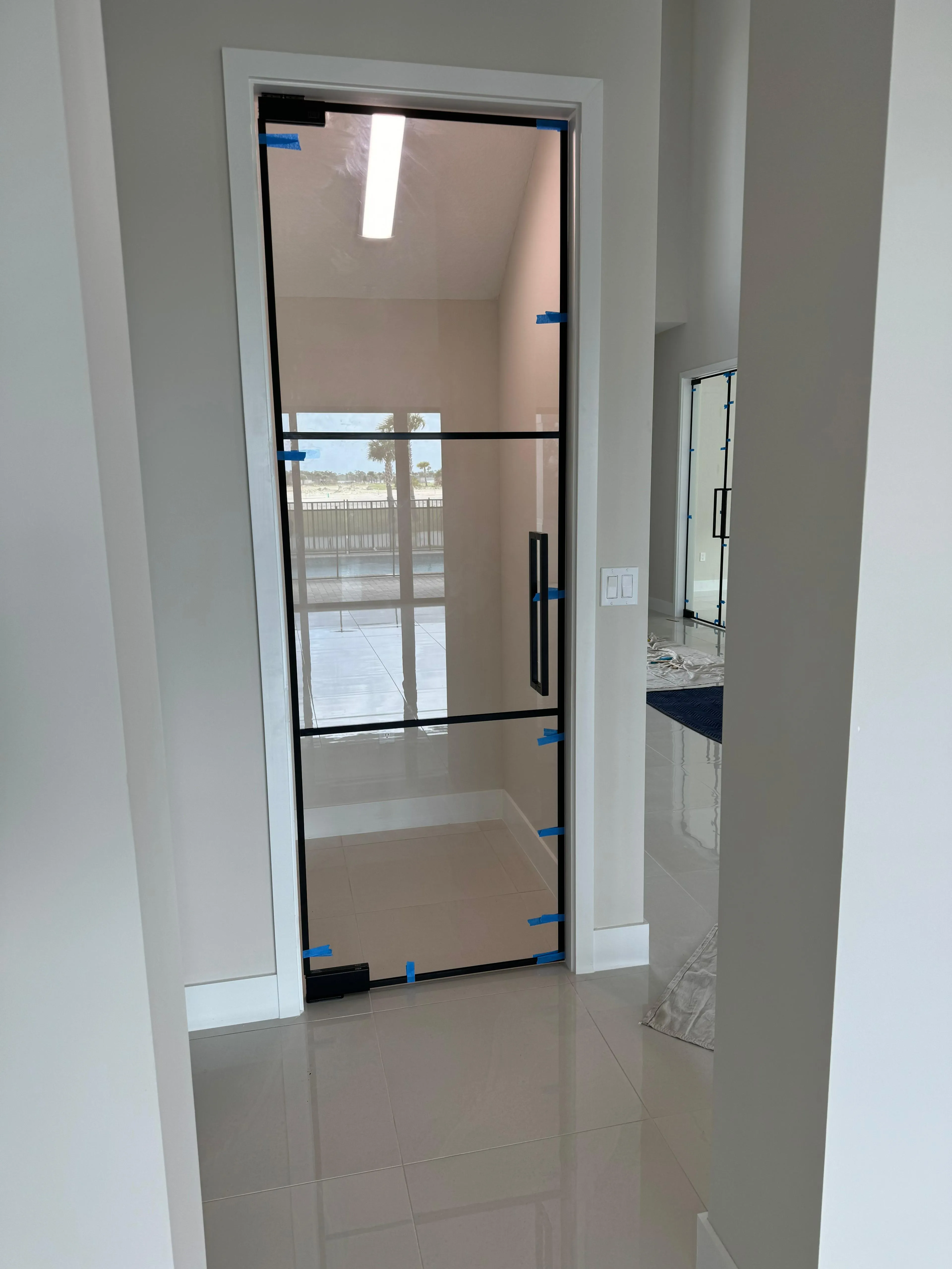 High-quality glass patio door with sleek black frame and secure handle.