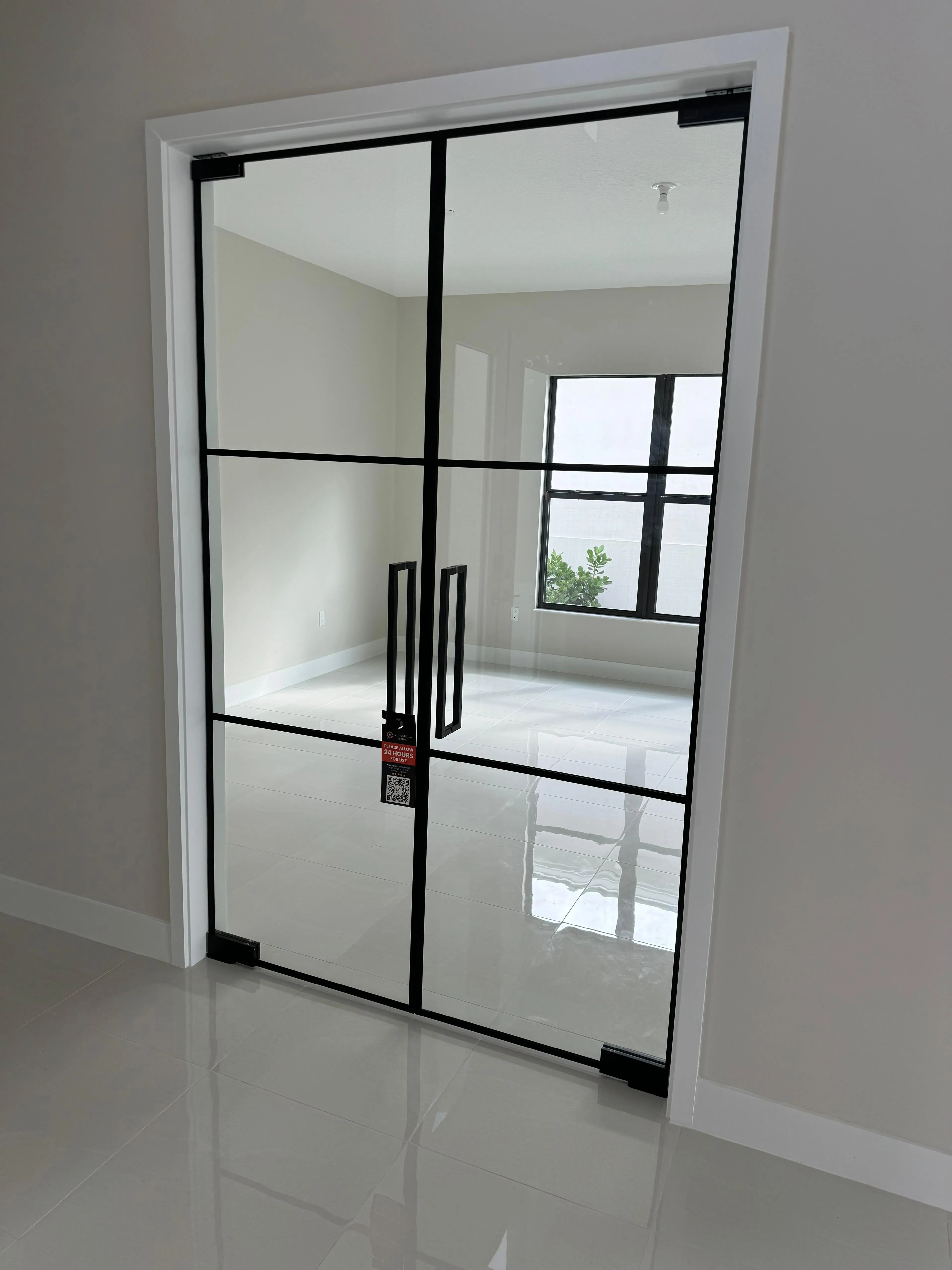 Stylish glass door featuring a modern black frame, perfect for interior or exterior use.