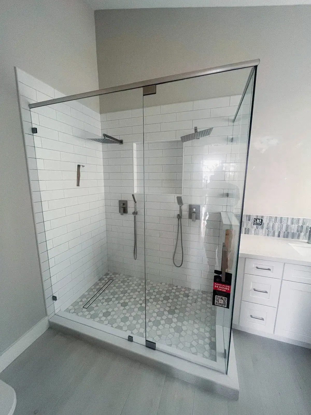 High-quality glass shower door with chrome accents and modern dual showerheads for a luxurious bathroom upgrade.