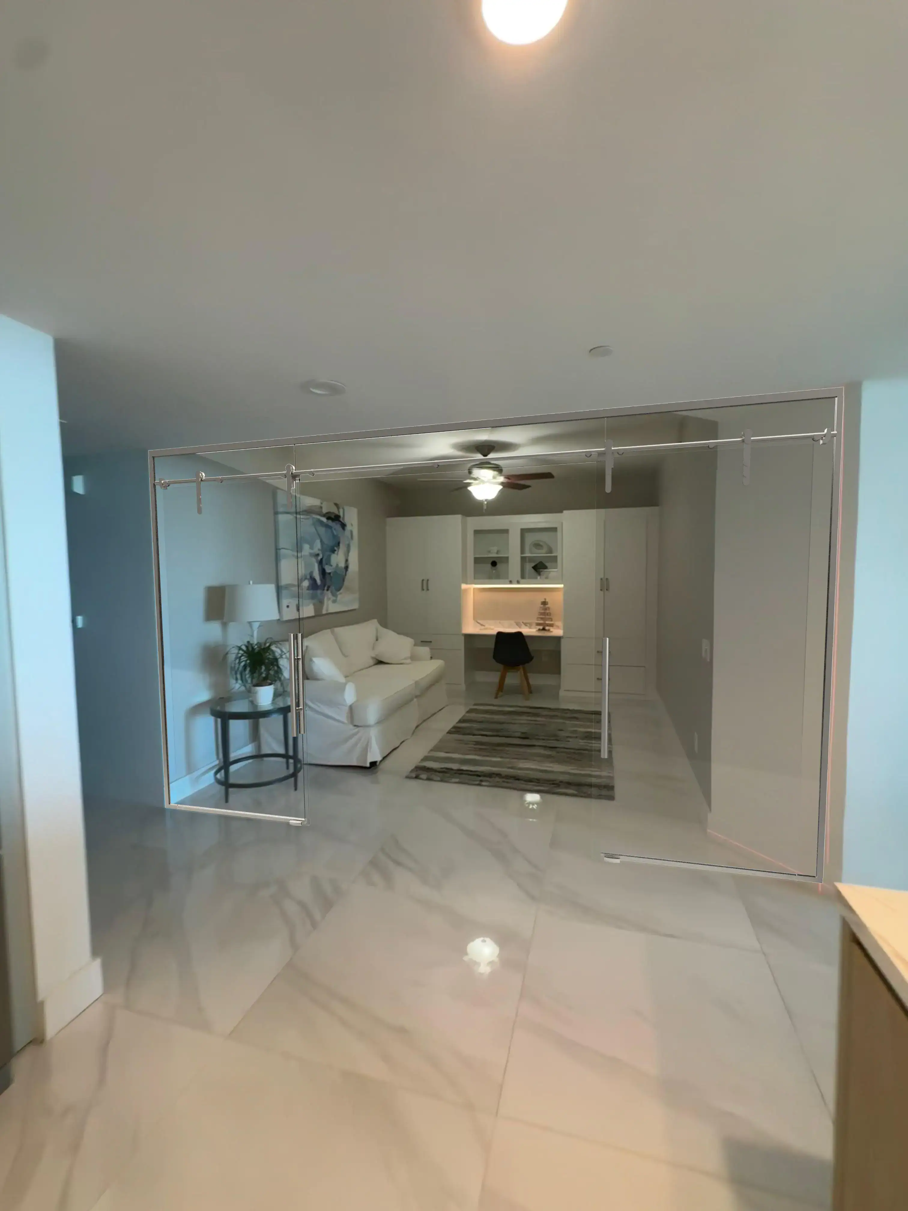 Stainless steel framed glass door divider in modern living space.