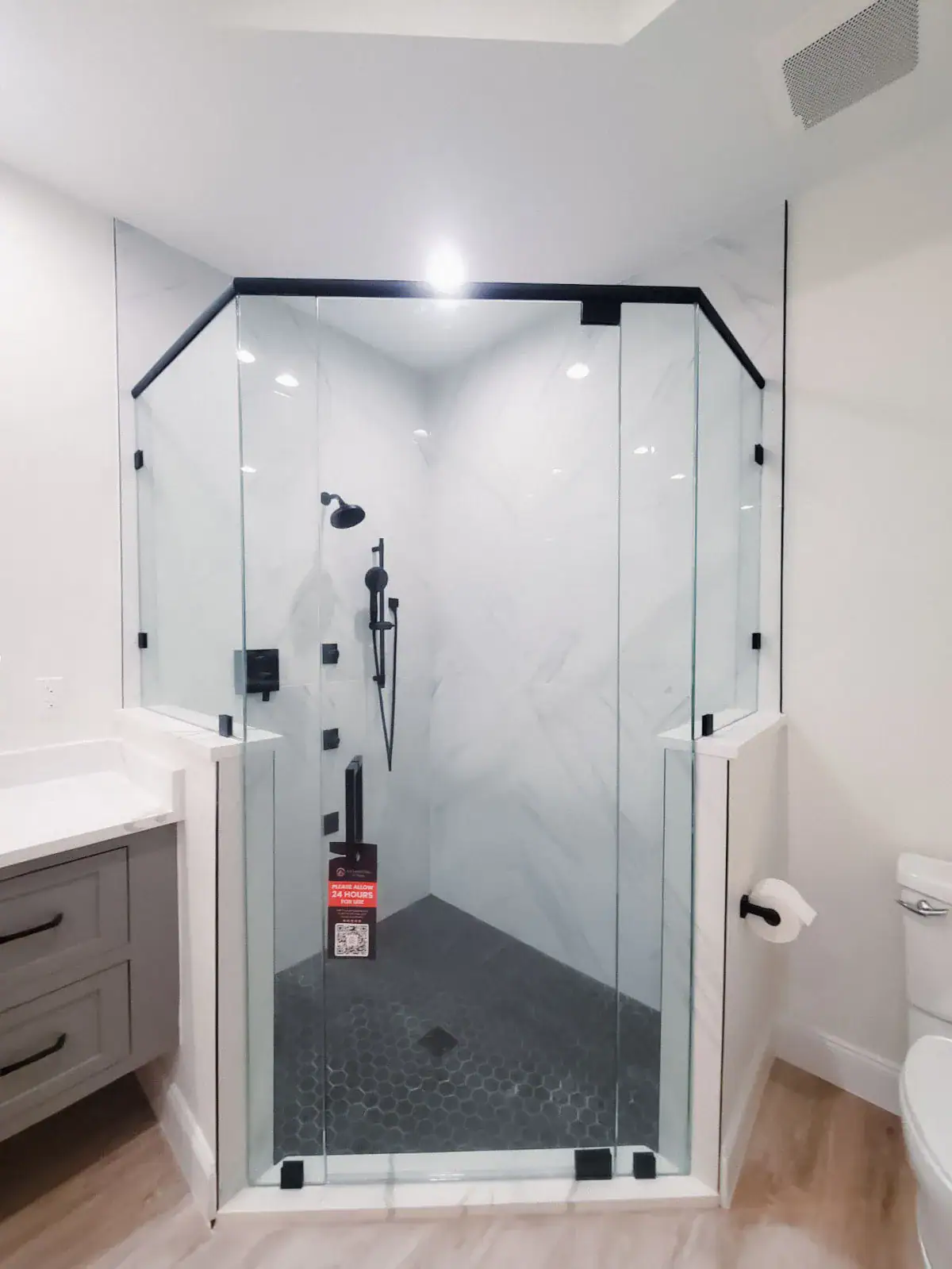 High-quality glass shower door with black hardware accents.