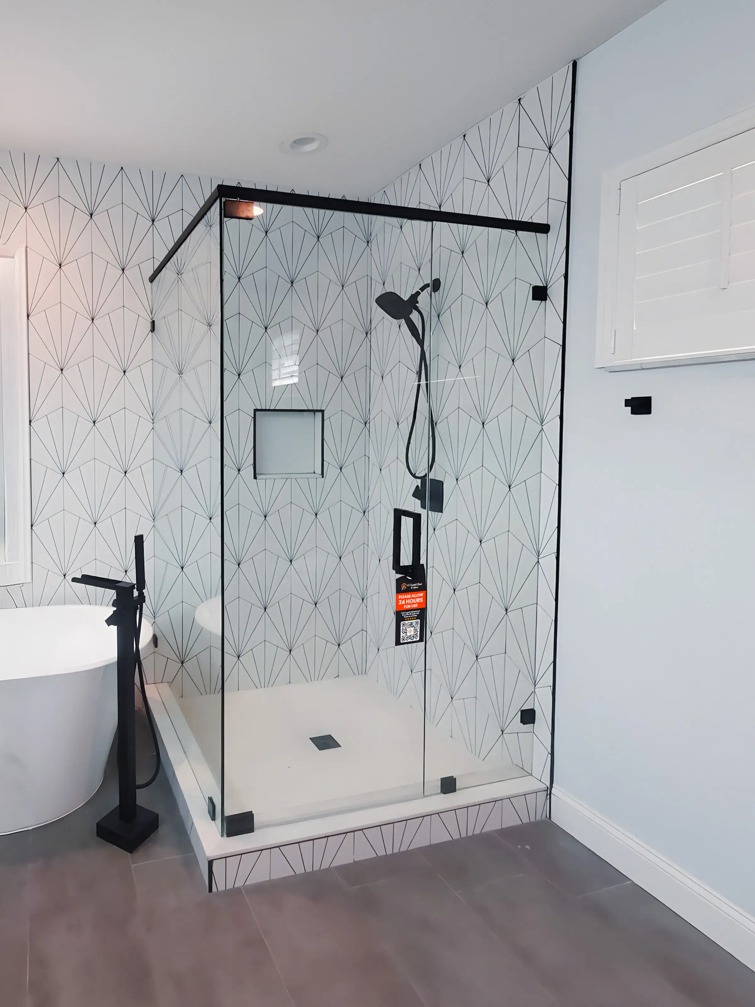 High-quality custom glass and mirror shower enclosure for modern bathrooms. Durable, clear glass with sleek black hardware.