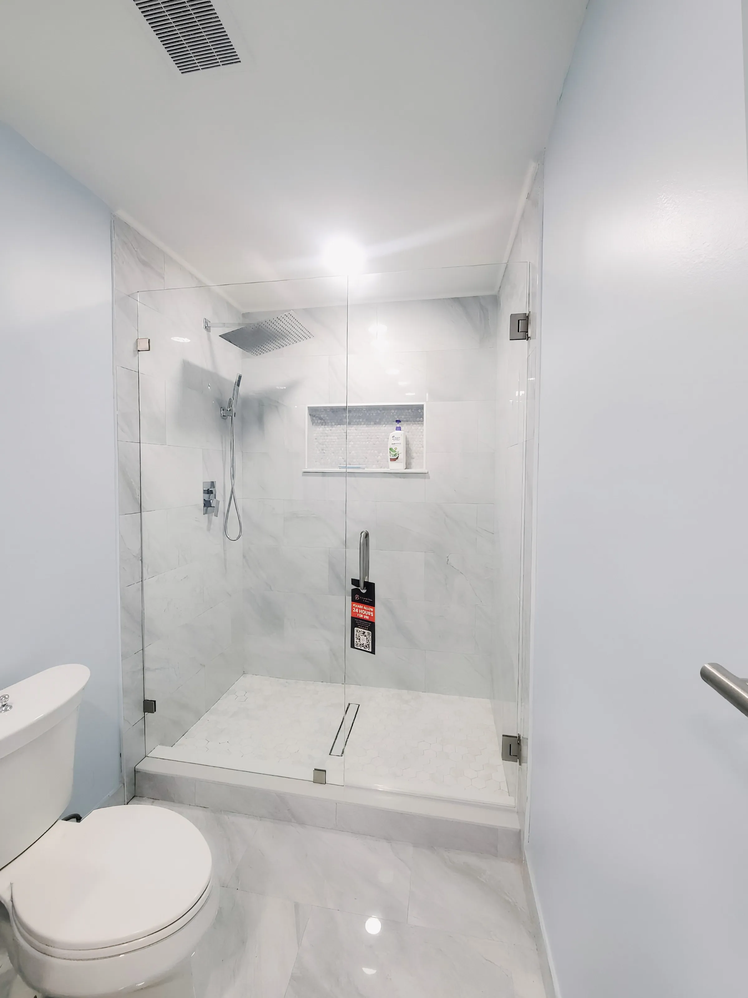 Bathroom glass shower door with sleek, frameless style and waterproof design.