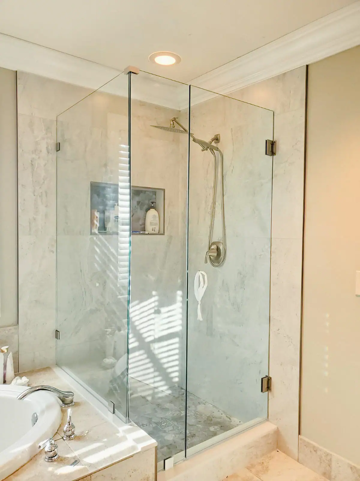Clear glass shower with sleek frameless design in modern bathroom setting.