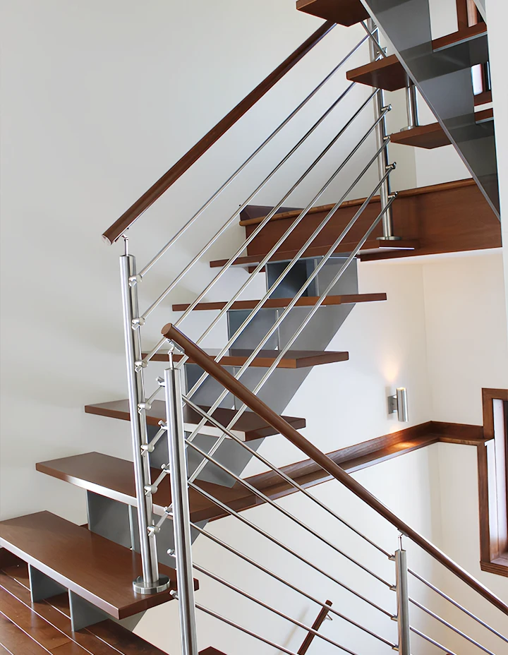 Modern metal and wood staircase with sleek railing design perfect for elegant interiors.