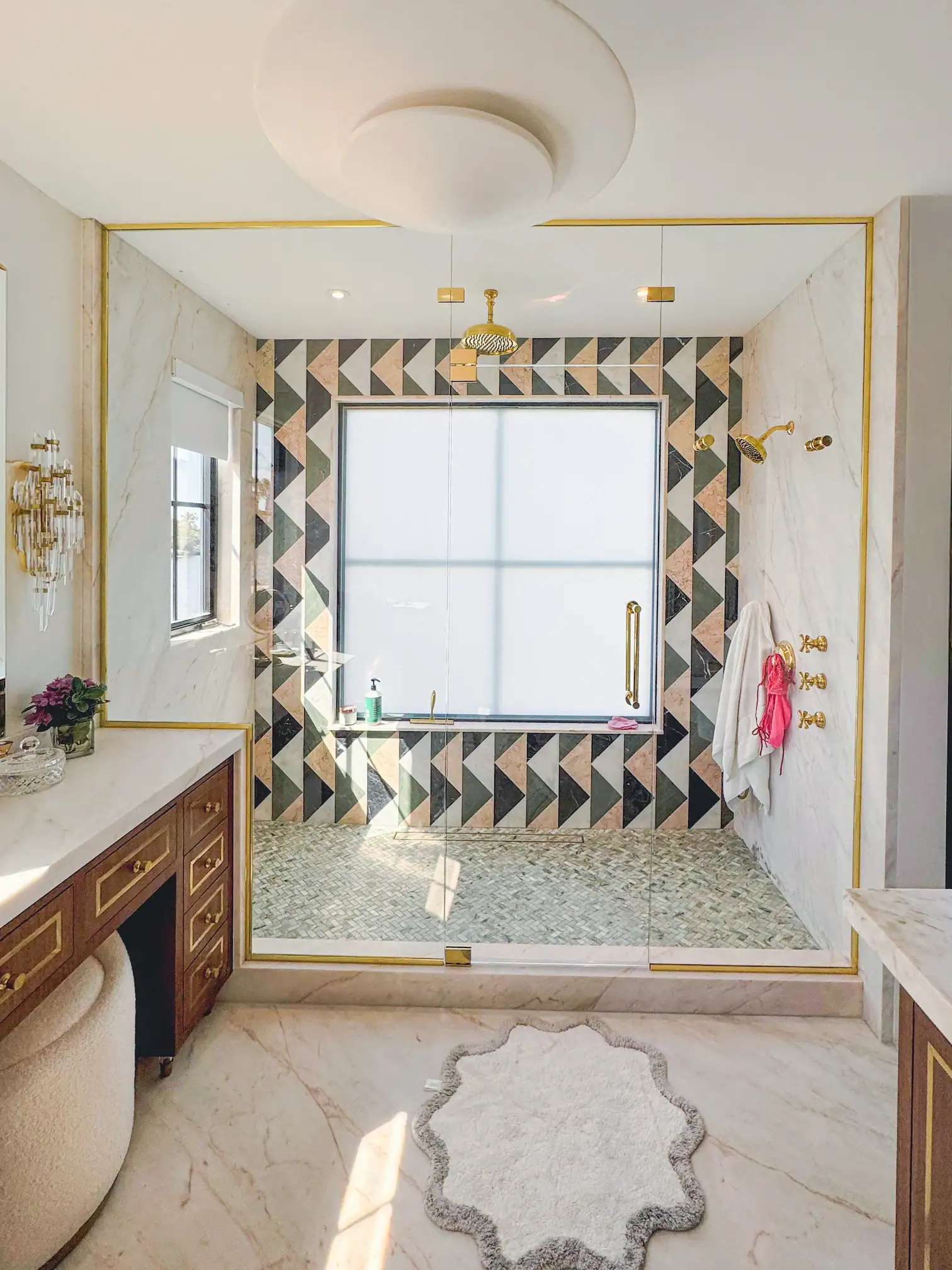Versatile glass shower with gold hardware, large window, and luxurious marble details. Perfect for upscale bathroom design.