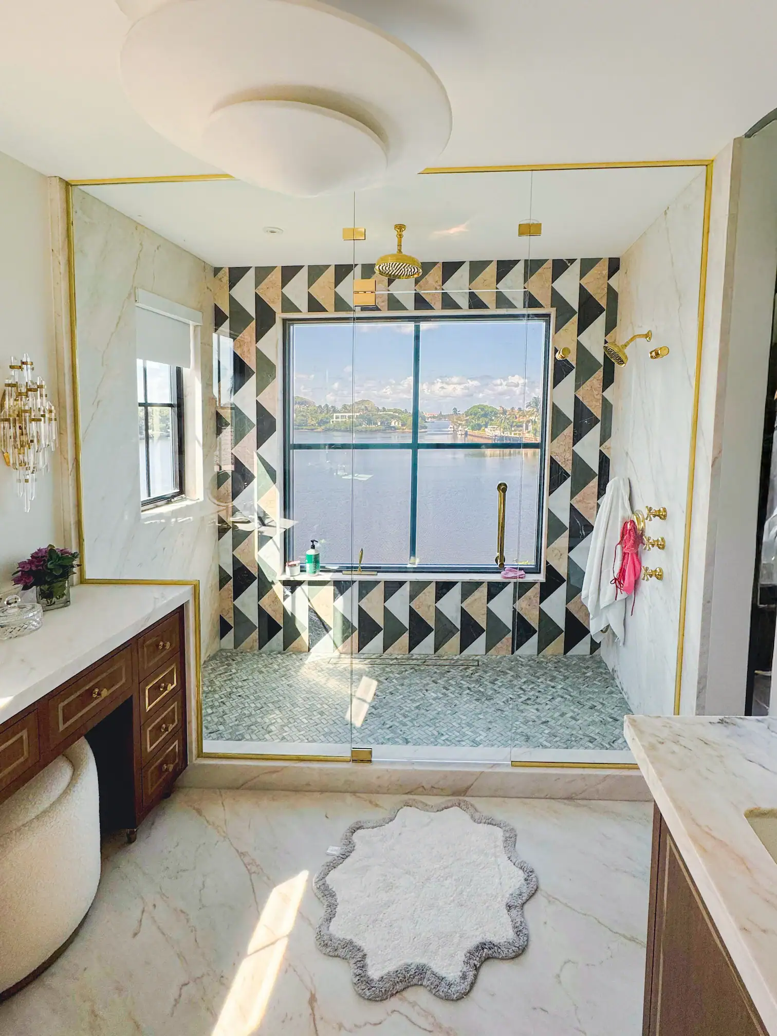 Elegant crystal glass mist shower door opening to scenic lake view.