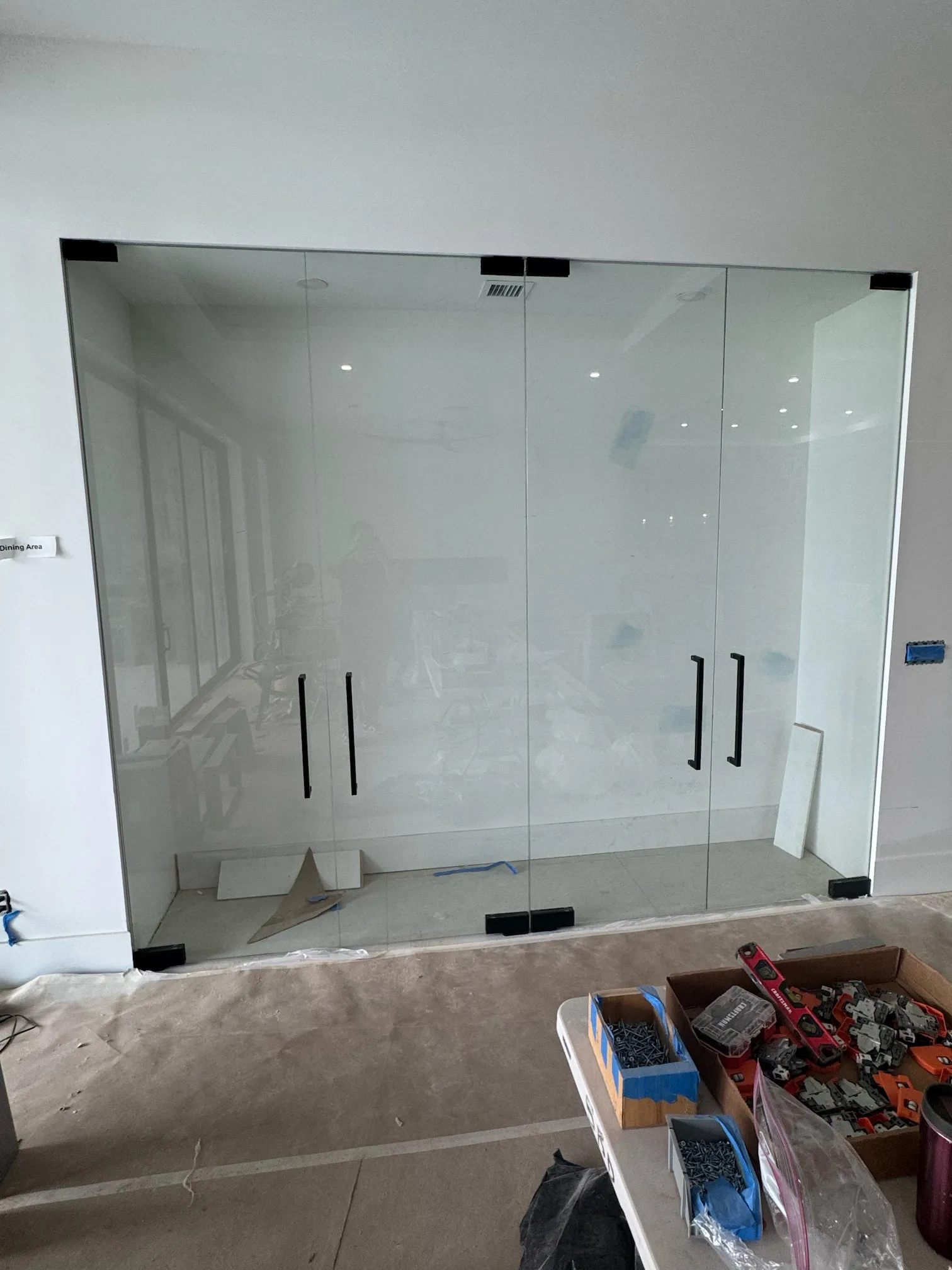 High-quality glass shower door installation with sleek black handles. Perfect for modern bathroom upgrades.