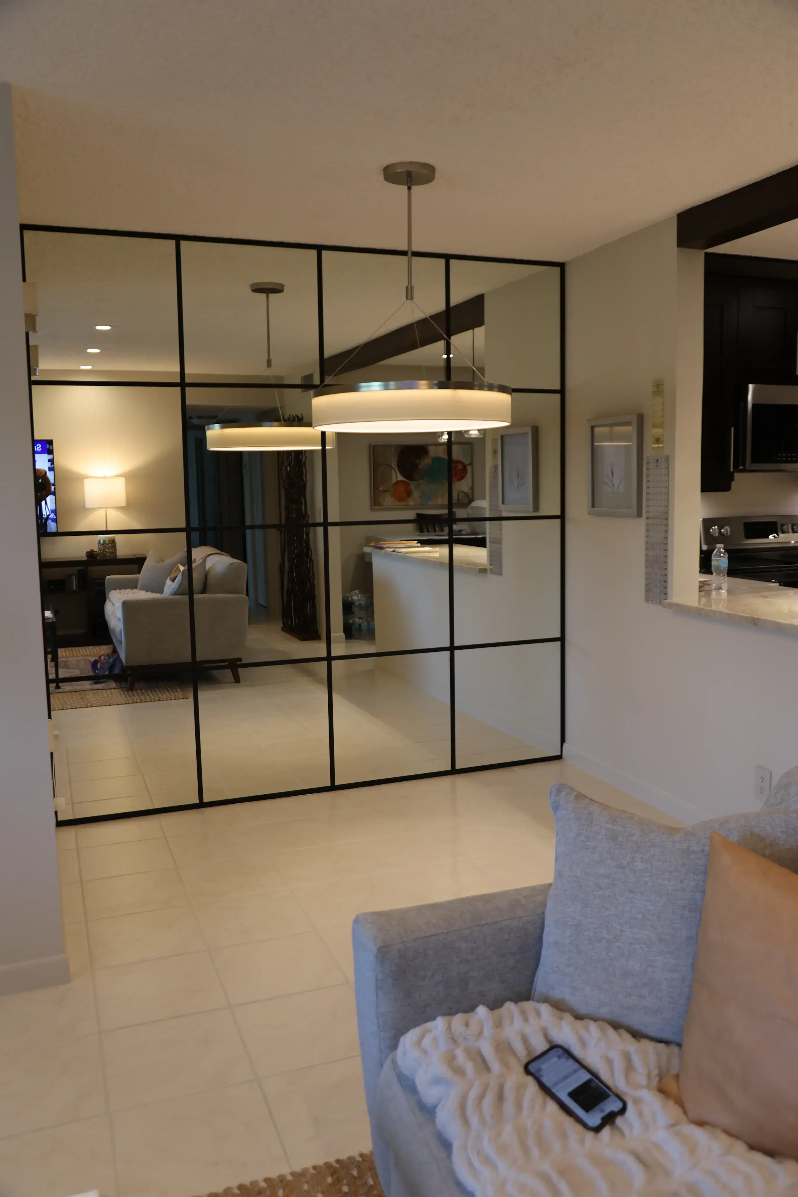 Elegant glass and mirror room divider for stylish interiors.