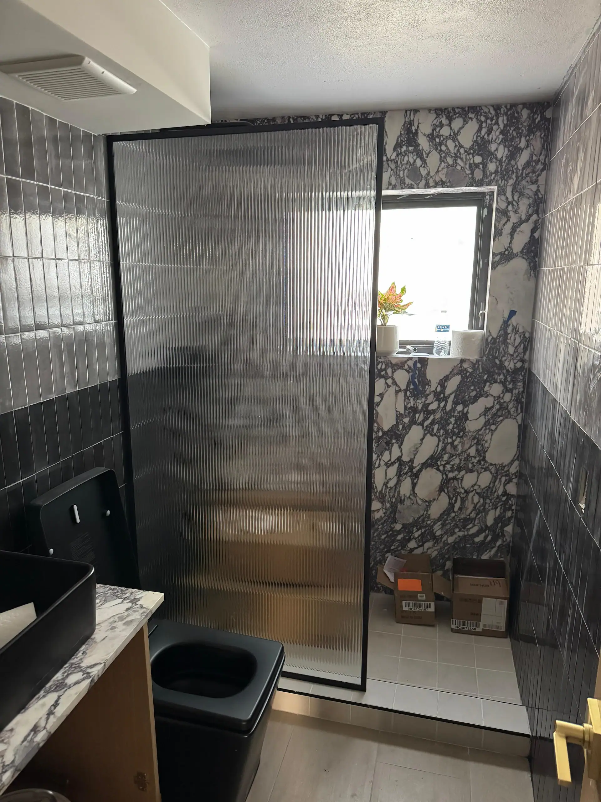 Durable textured acrylic glass shower door in contemporary bathroom design.