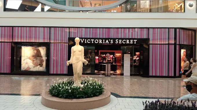 Custom mirror display at The Gardens Mall with Victoria's Secret storefront in background.
