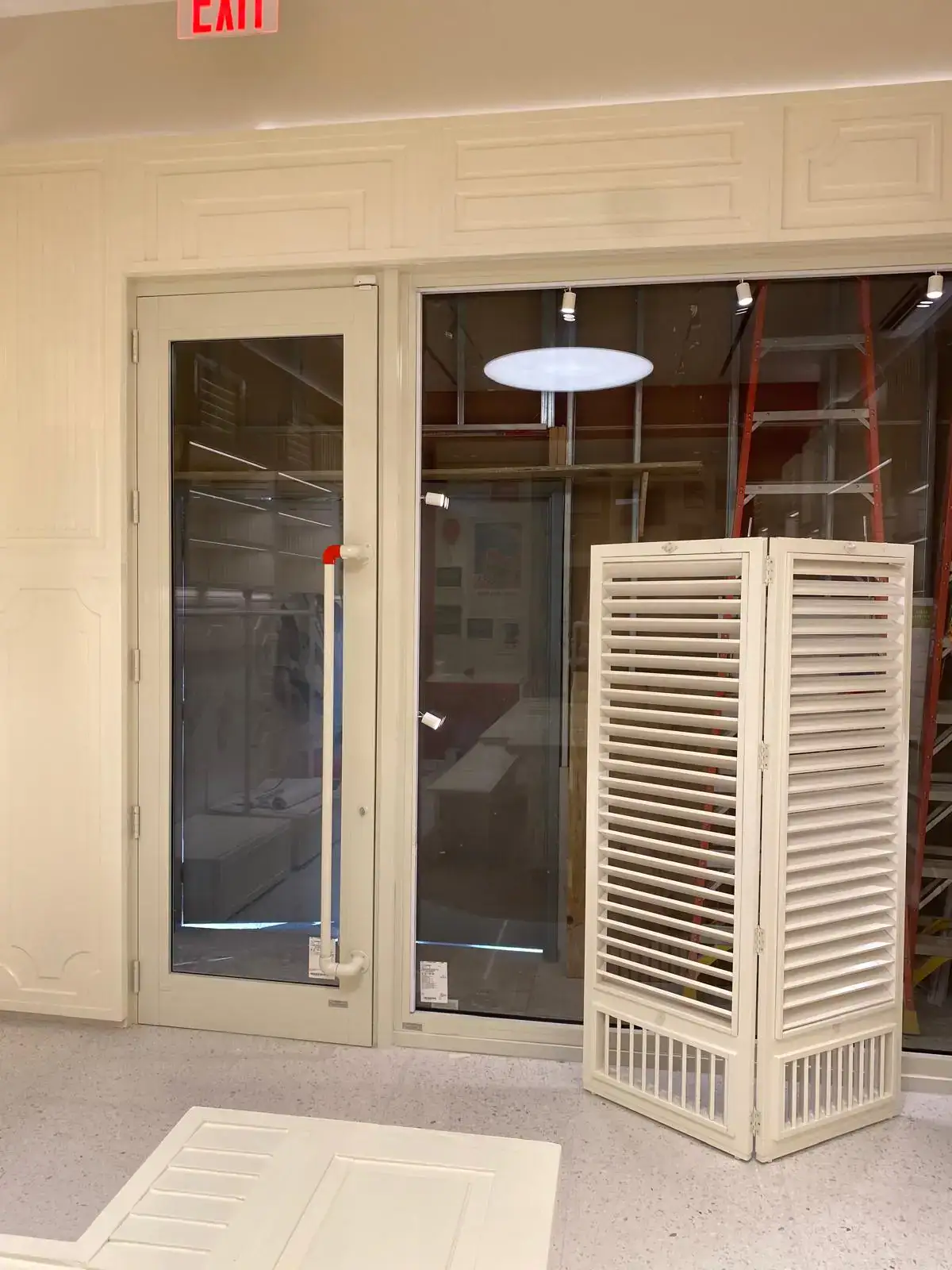 Alt text: Beveled glass door with mirror surface and white frame, stylish and functional.