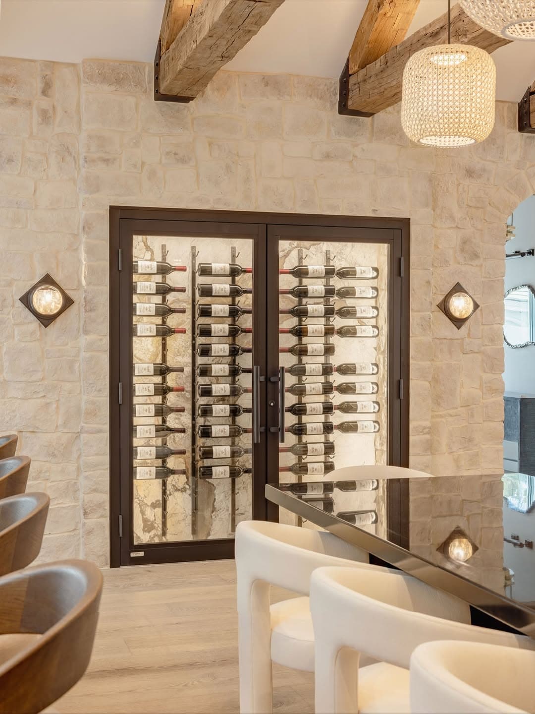 Crystal glass wine cellar door showcasing modern wine storage in a stylish home or restaurant setting.