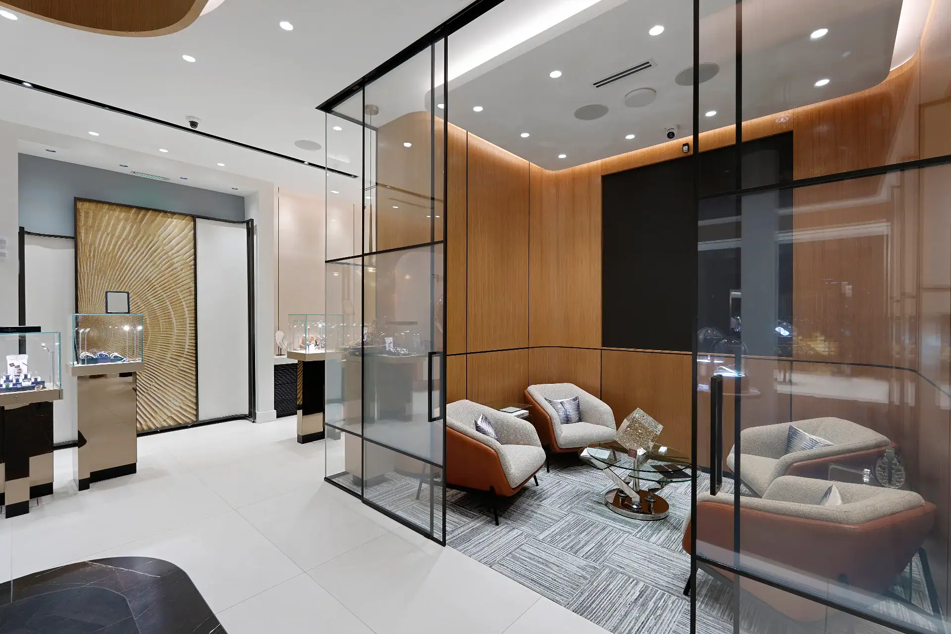 Elegant glass and mirror installation in jewelry store setting.