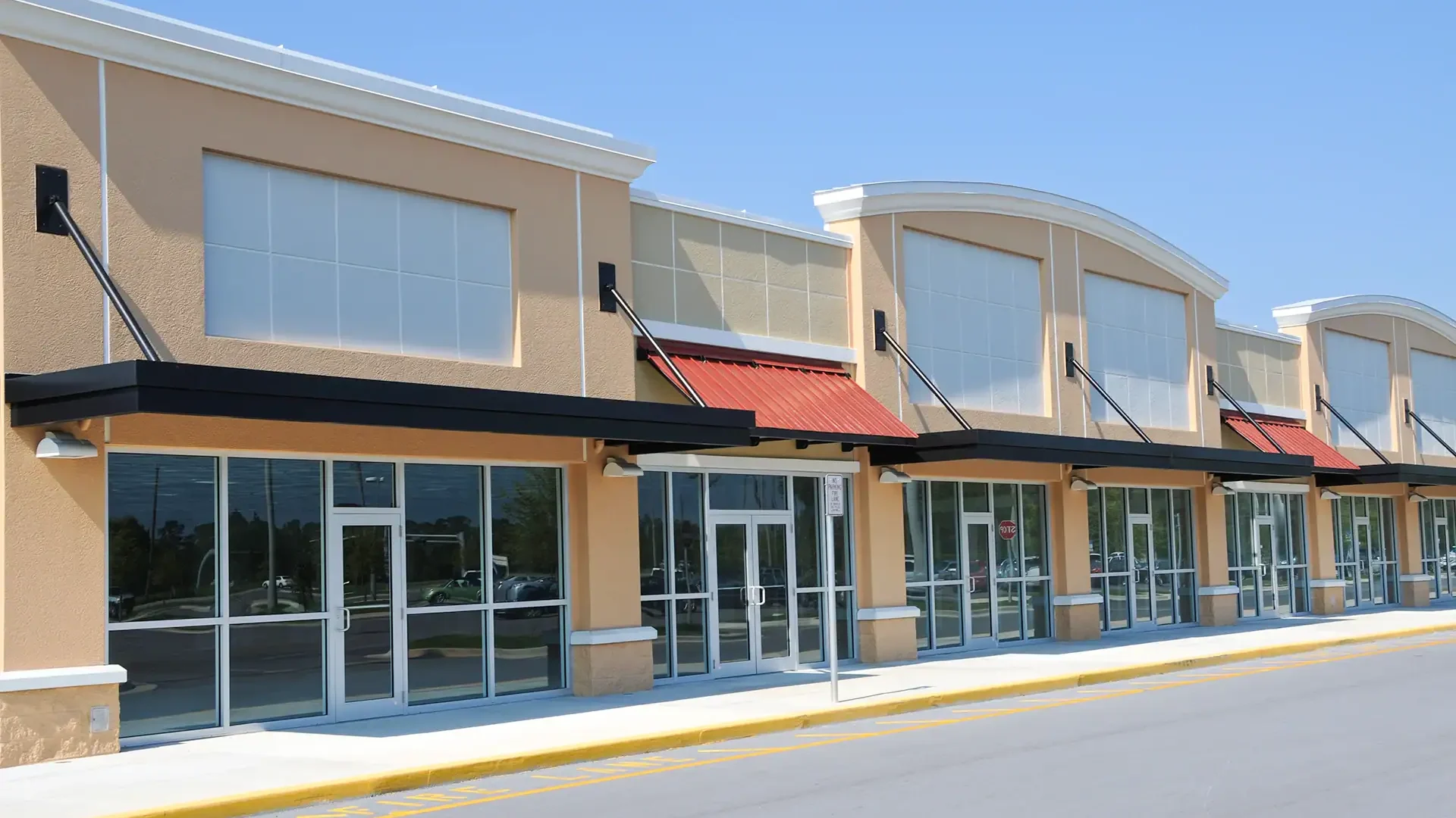 Bright commercial building with glass storefronts.
