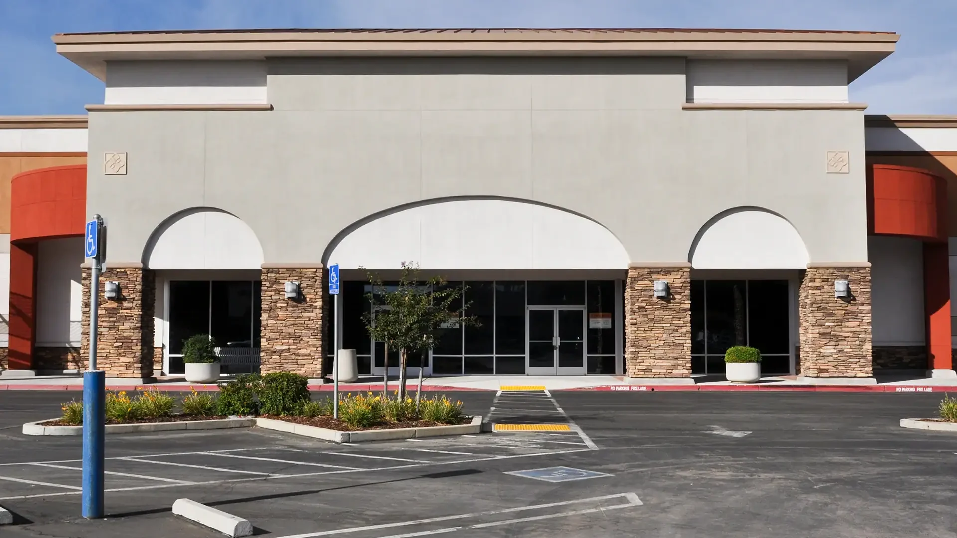 Modern storefront with glass windows and stone accents.