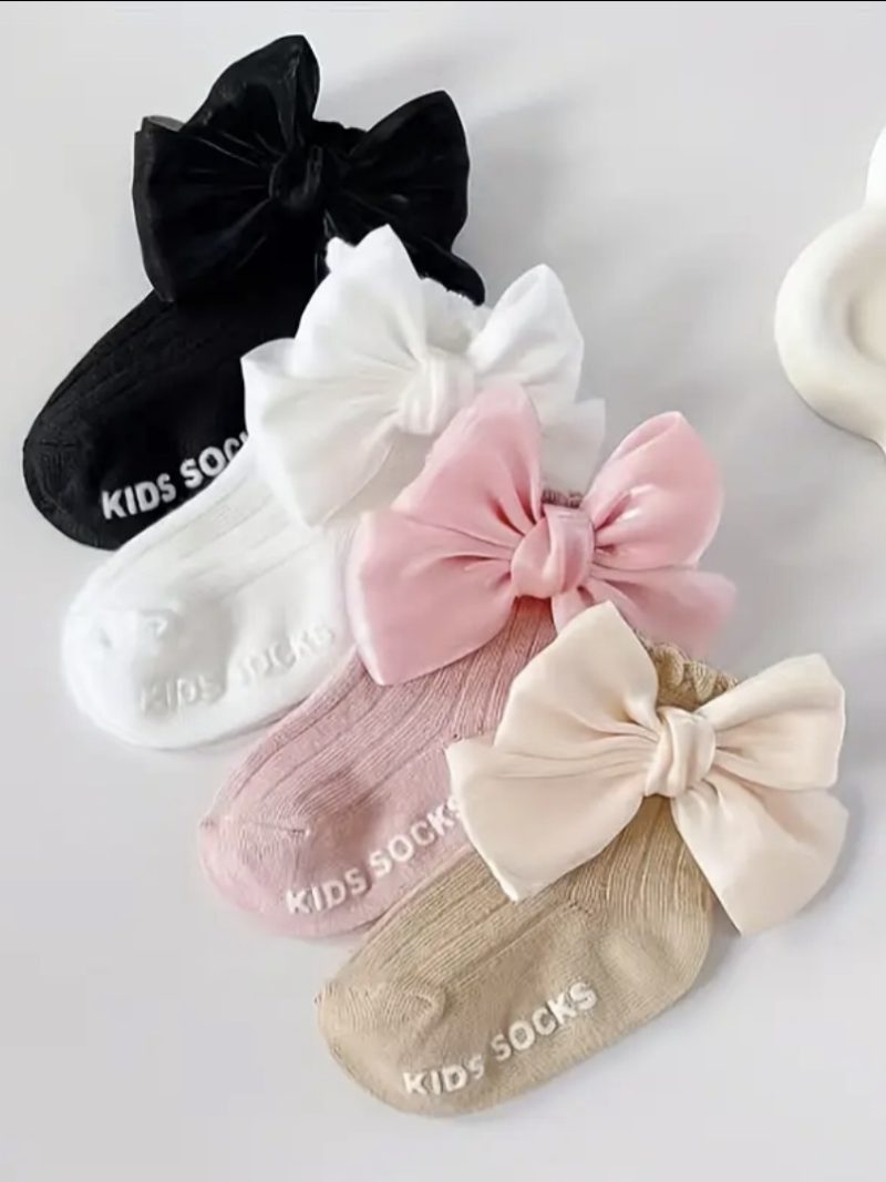 Calcetines de bebé con lazo en colores pastel y negro, perfectos para bebés niñas, cómodos y adorables.
